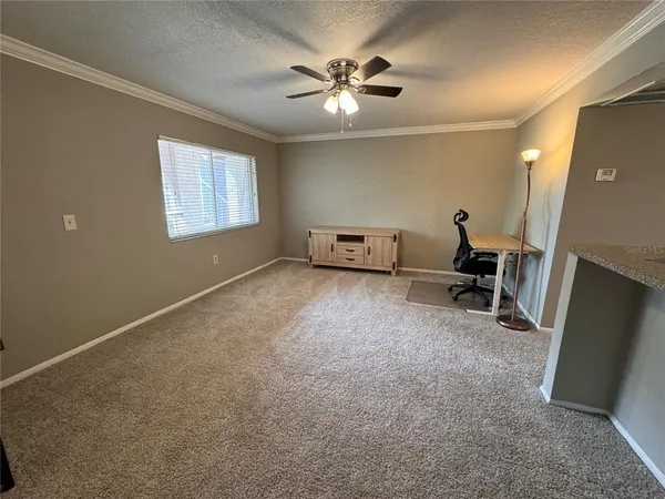 a view of work room with furniture and a ceiling fan