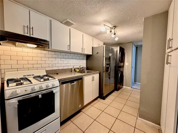 a kitchen with a stove sink and refrigerator