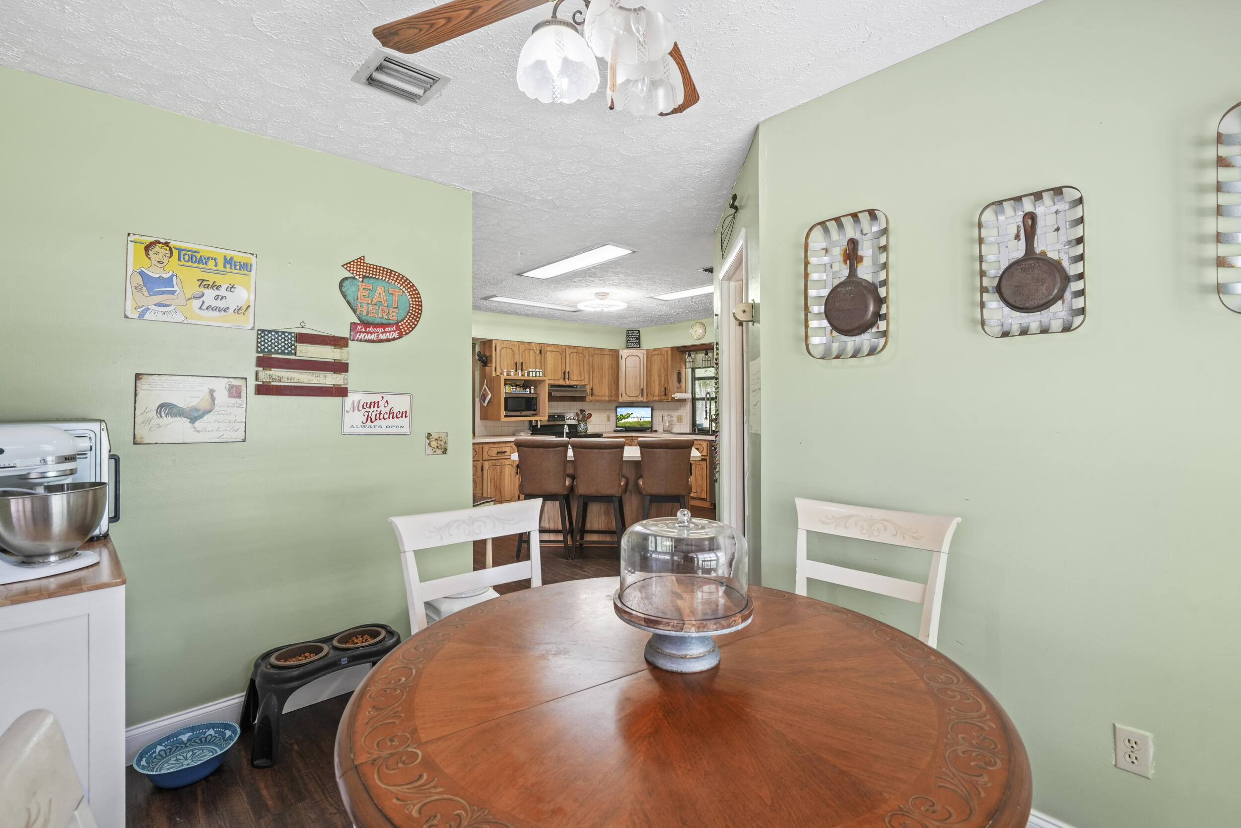4170 McCarty Road Fort Pierce, FL 34945 - Photo 21 of 57 a dining room with a table and chairs
