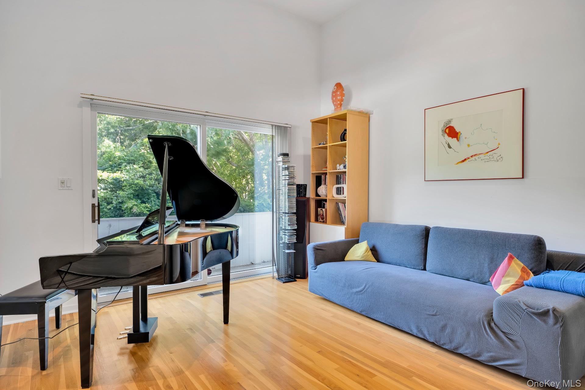 30 Pheasant Run Quogue, NY 11959 - Photo 11 of 26 a living room with furniture and a flat screen tv