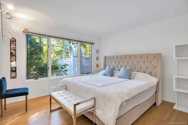 a bedroom with a bed and a window with outer view
