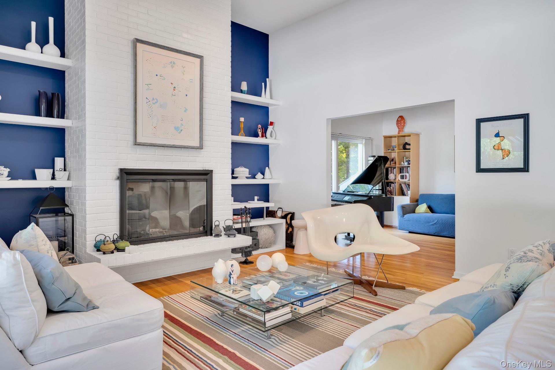 30 Pheasant Run Quogue, NY 11959 - Photo 18 of 26 a living room with furniture and a fireplace