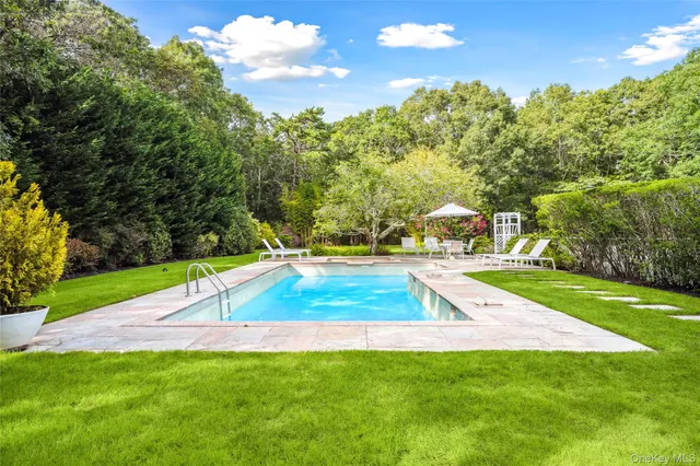 a view of a backyard with swimming pool