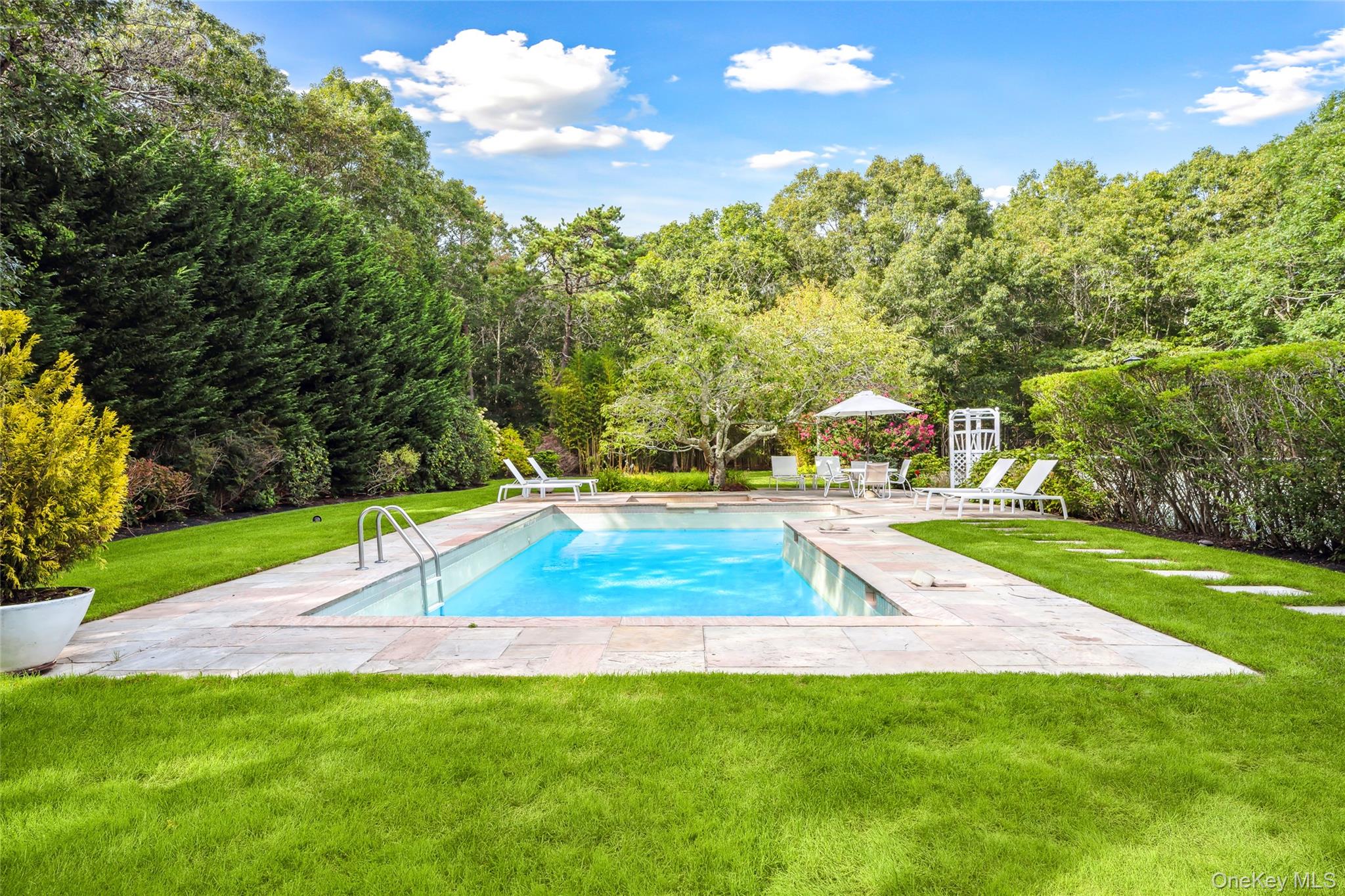 30 Pheasant Run Quogue, NY 11959 - Photo 24 of 26 a view of a backyard with swimming pool