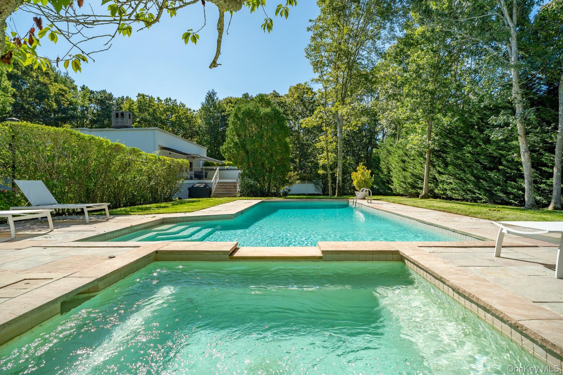 30 Pheasant Run Quogue, NY 11959 - Photo 25 of 26 a view of a swimming pool with a yard