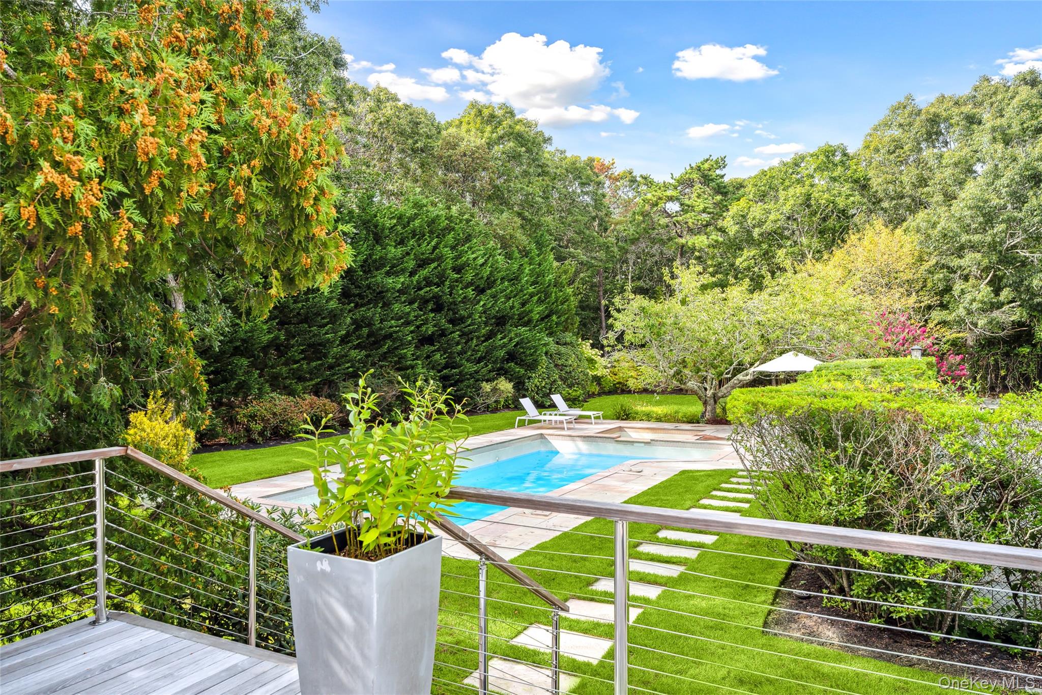 30 Pheasant Run Quogue, NY 11959 - Photo 3 of 26 a view of a balcony with floor to ceiling windows and wooden fence
