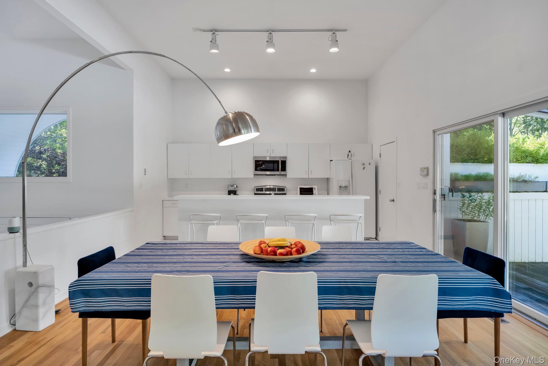 30 Pheasant Run Quogue, NY 11959 - Photo 6 of 26 a kitchen with stainless steel appliances granite countertop a kitchen island a stove a table and chairs in it