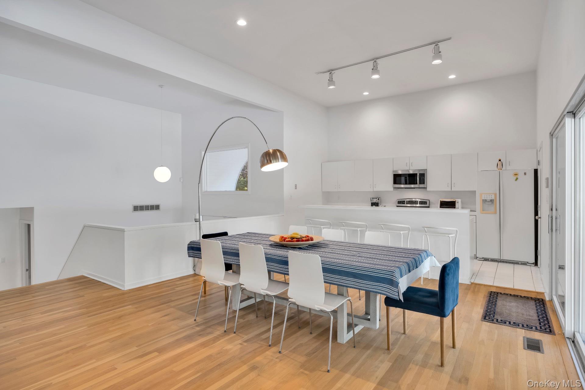 30 Pheasant Run Quogue, NY 11959 - Photo 7 of 26 a view of kitchen with cabinets and wooden floor