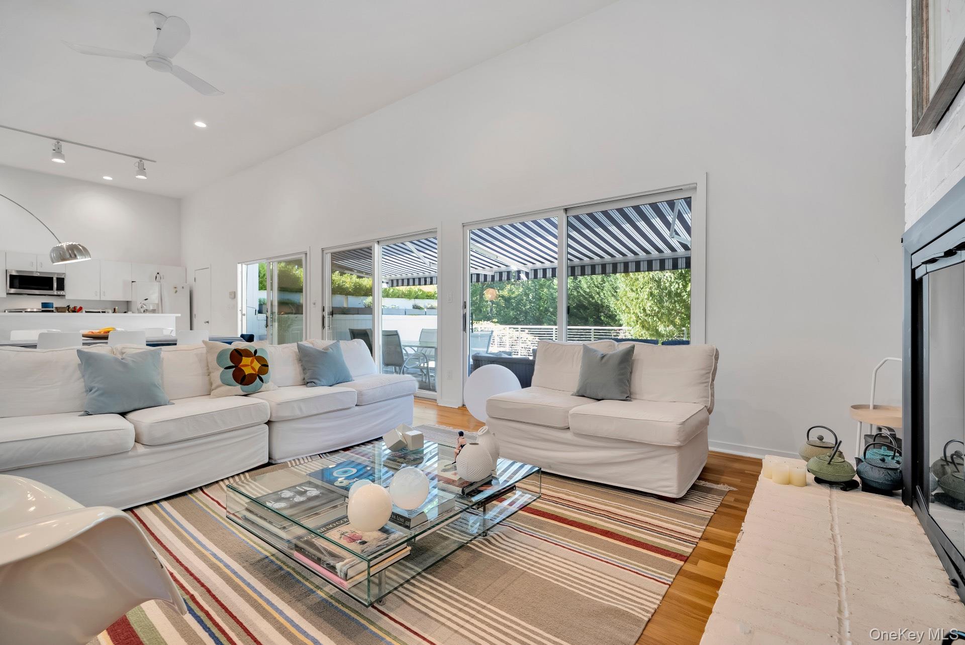 30 Pheasant Run Quogue, NY 11959 - Photo 9 of 26 a living room with furniture and a large window