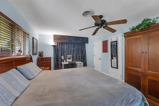 a large bedroom with a bed and a chandelier