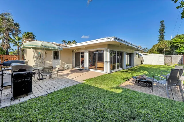 a view of a house with backyard porch and sitting area