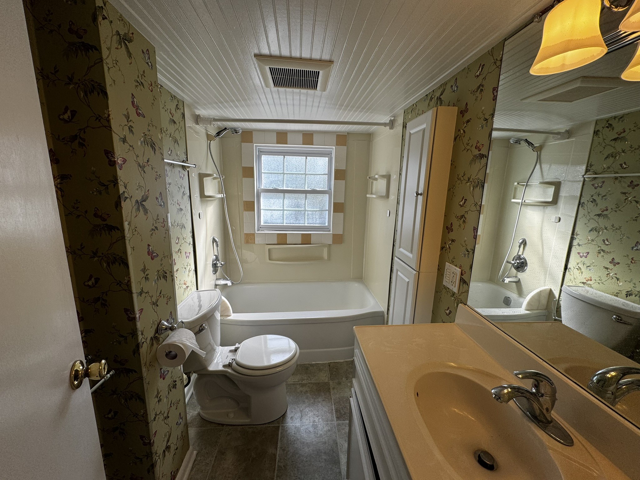 105 Wilson Street Cowan, TN 37318 - Photo 25 of 57 a bathroom with a sink and mirror with bathtub