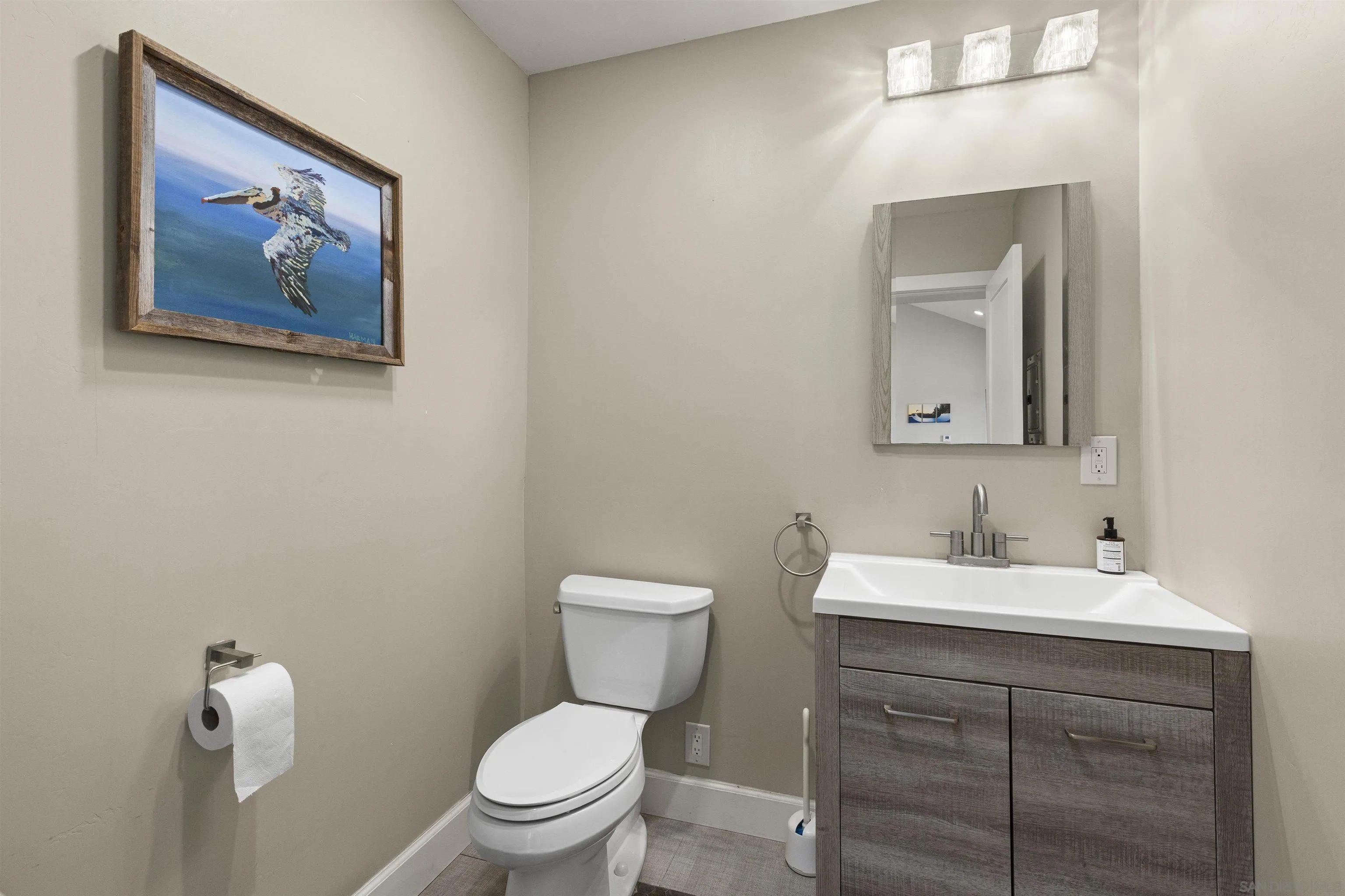 752 Bracero Road Encinitas, CA 92024 - Photo 18 of 46 a bathroom with a toilet a sink and mirror