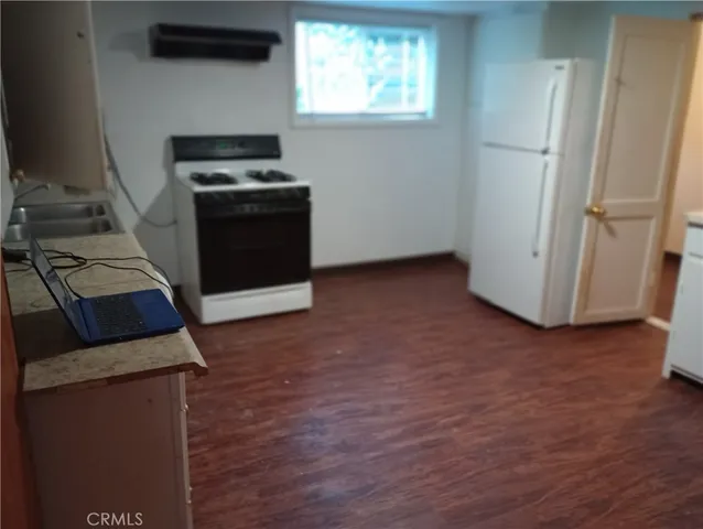 a view of backyard with a tub and trees in the background