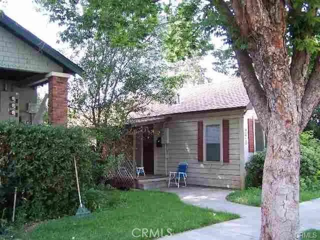 a front view of house with yard and outdoor seating