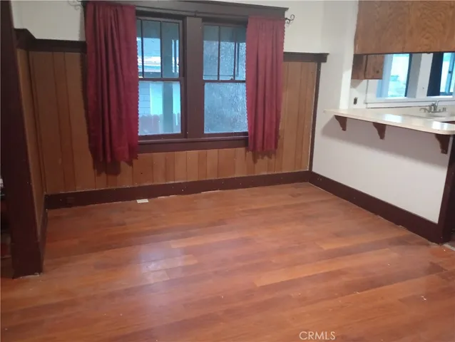 a kitchen with a sink a stove a refrigerator and cabinets