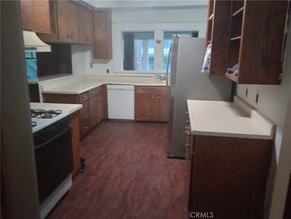 a utility room with wooden floor washer and dryer