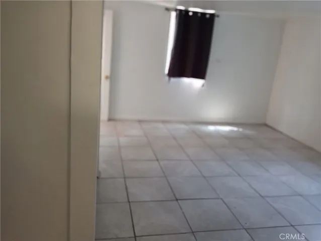a kitchen with a refrigerator stove and wooden floor
