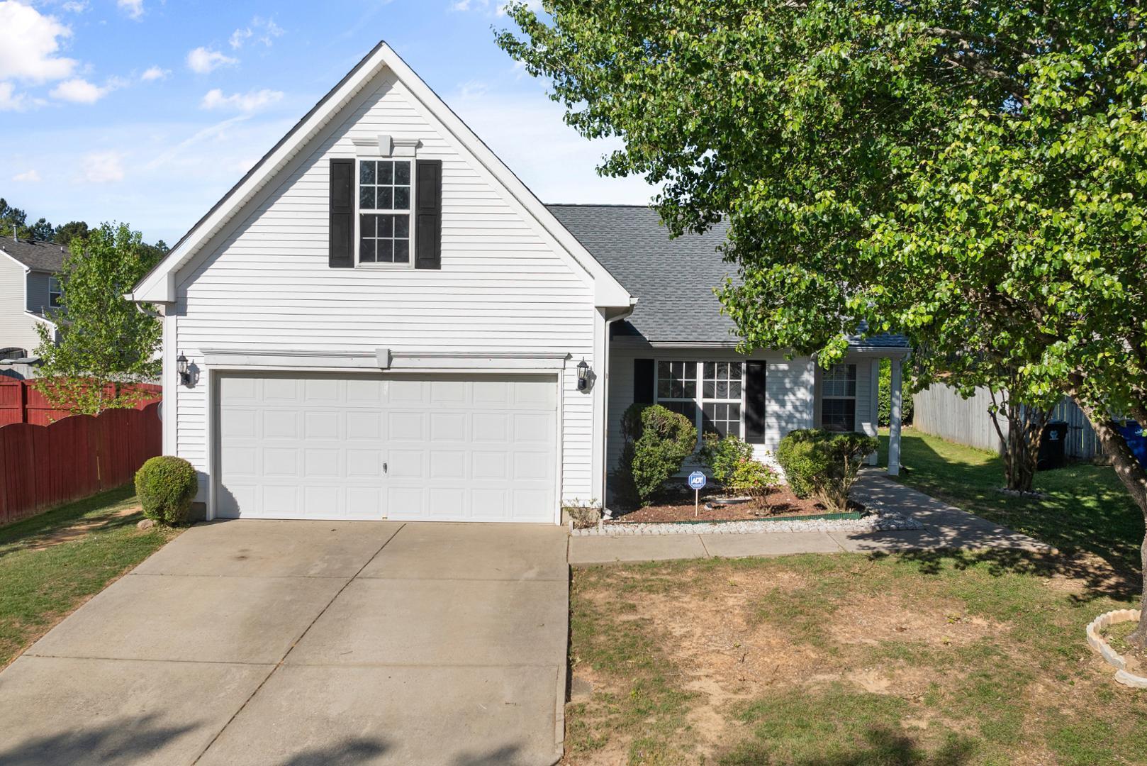 a view of a house with a yard and garage