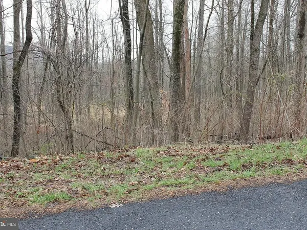 a view of wooden fence and trees