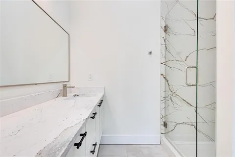 a bathroom with a double vanity sink and mirror