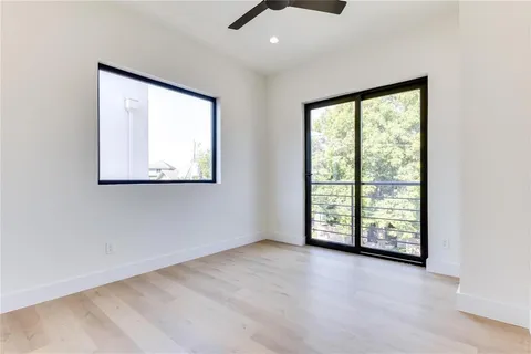 an empty room with windows and closet