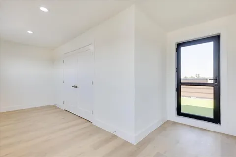 an empty room with windows and closet