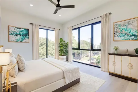 a bedroom with a large bed and a window