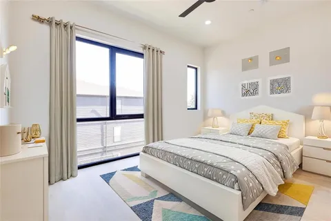 a spacious bedroom with a bed and a window
