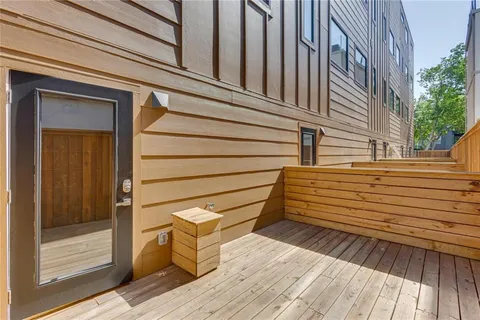 a view of a wooden chairs on the side of a building