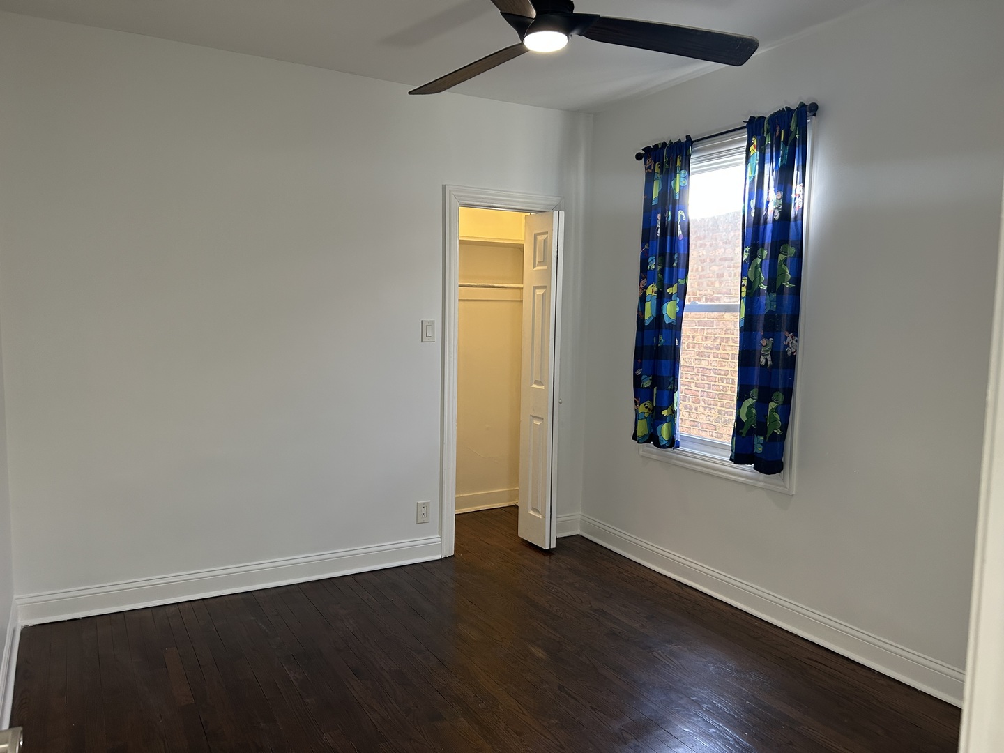 4858 West Concord Place, Unit 1 Chicago, IL 60639 - Photo 12 of 14 an empty room with wooden floor and windows