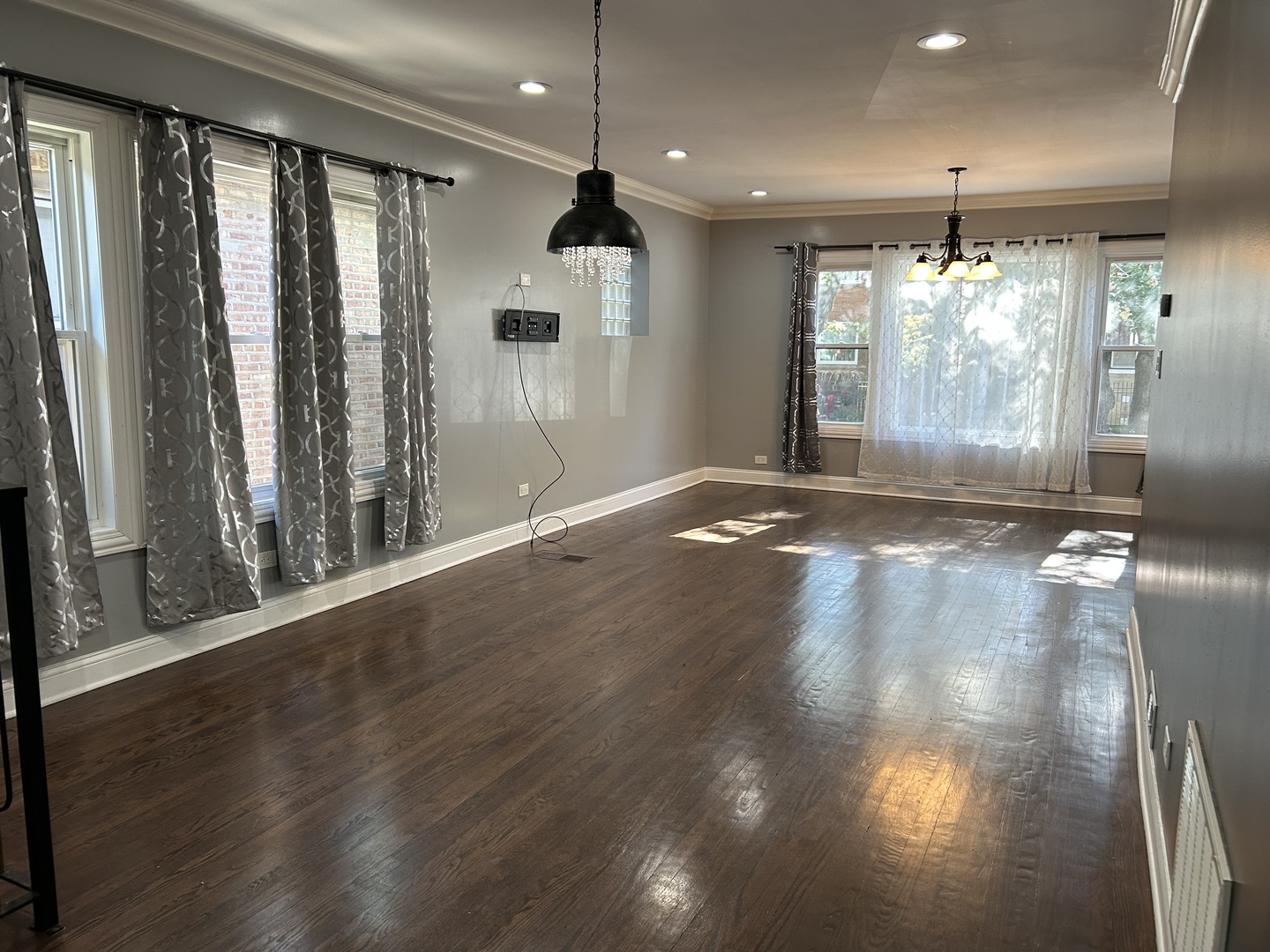 4858 West Concord Place, Unit 1 Chicago, IL 60639 - Photo 7 of 14 an empty room with wooden floor and windows