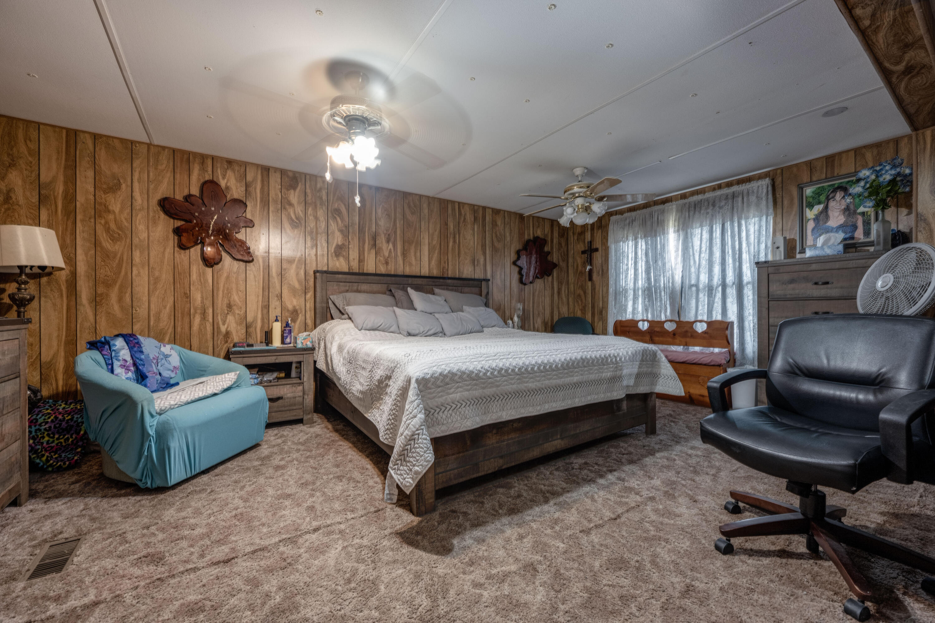 248 Bunny Lane Freeport, FL 32439 - Photo 12 of 27 a bedroom with a bed window and a chair