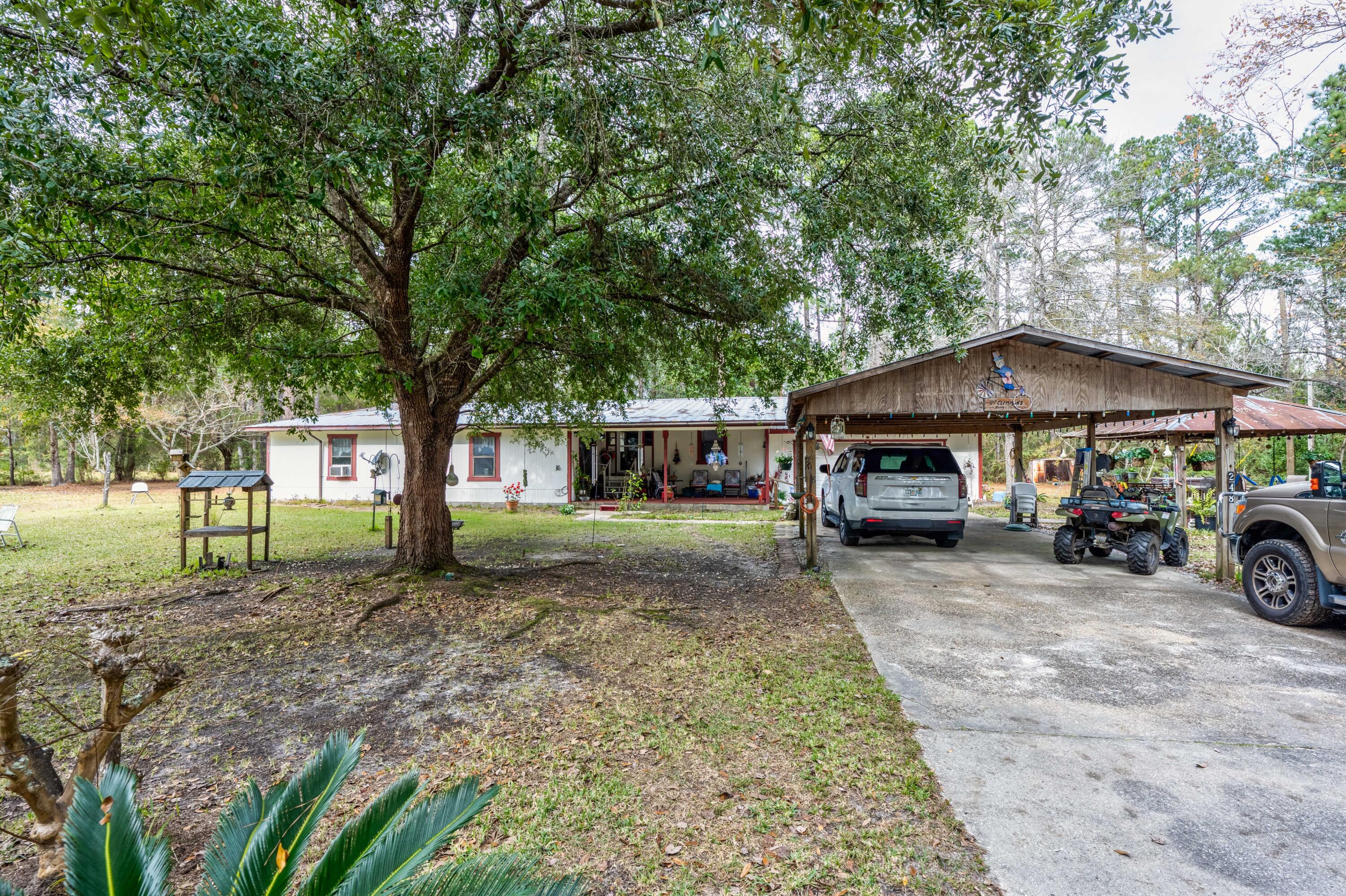 248 Bunny Lane Freeport, FL 32439 - Photo 20 of 27 a view of a house with a yard and large trees