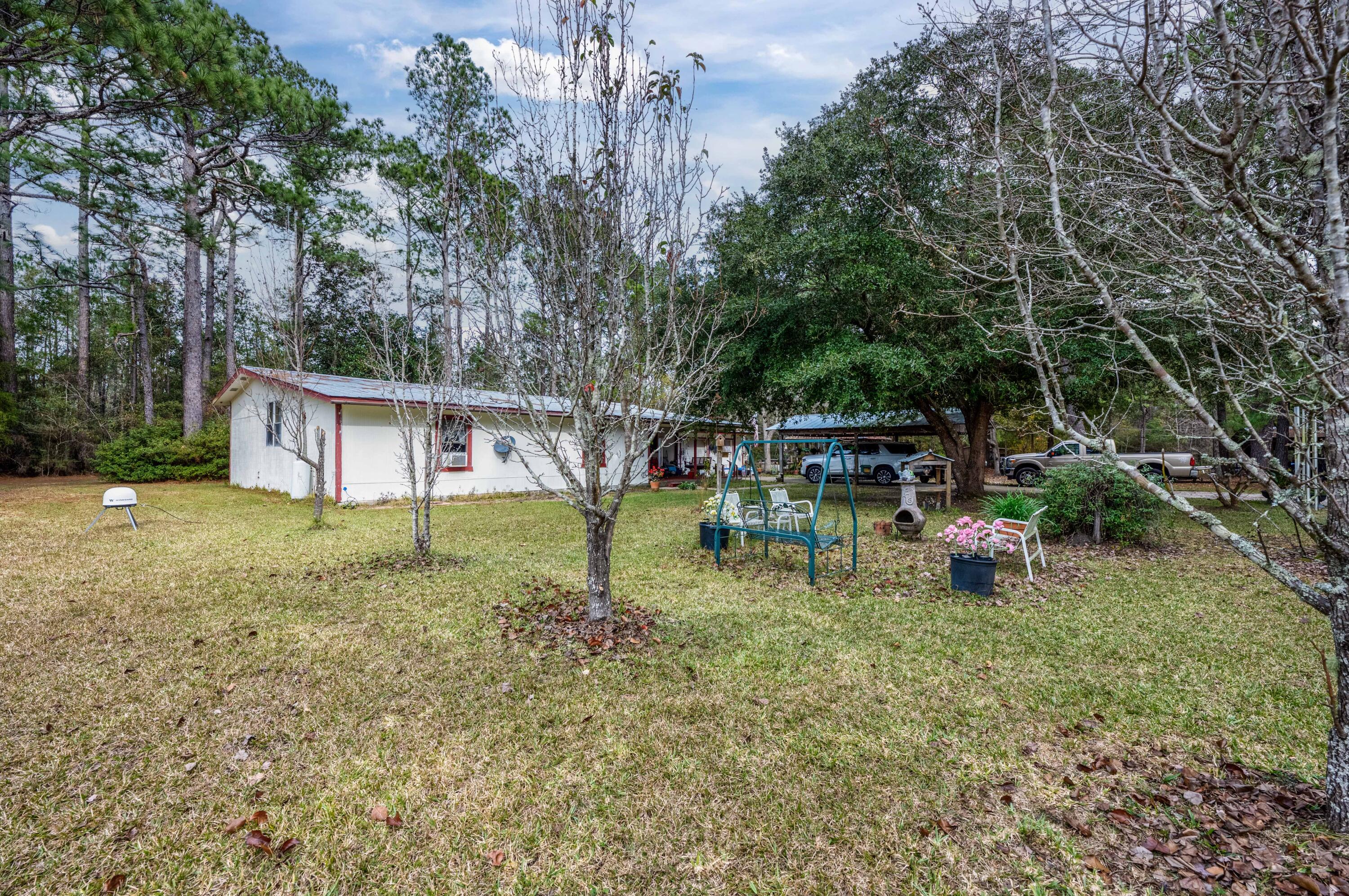 248 Bunny Lane Freeport, FL 32439 - Photo 22 of 27 a backyard of a house with table and chairs