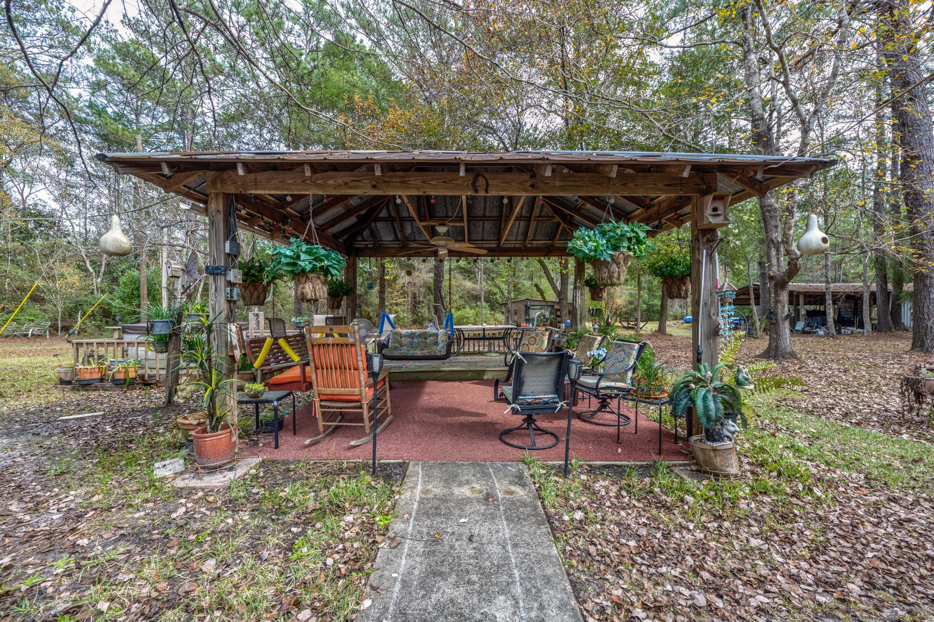 248 Bunny Lane Freeport, FL 32439 - Photo 24 of 27 a view of a patio with table and chairs under an umbrella