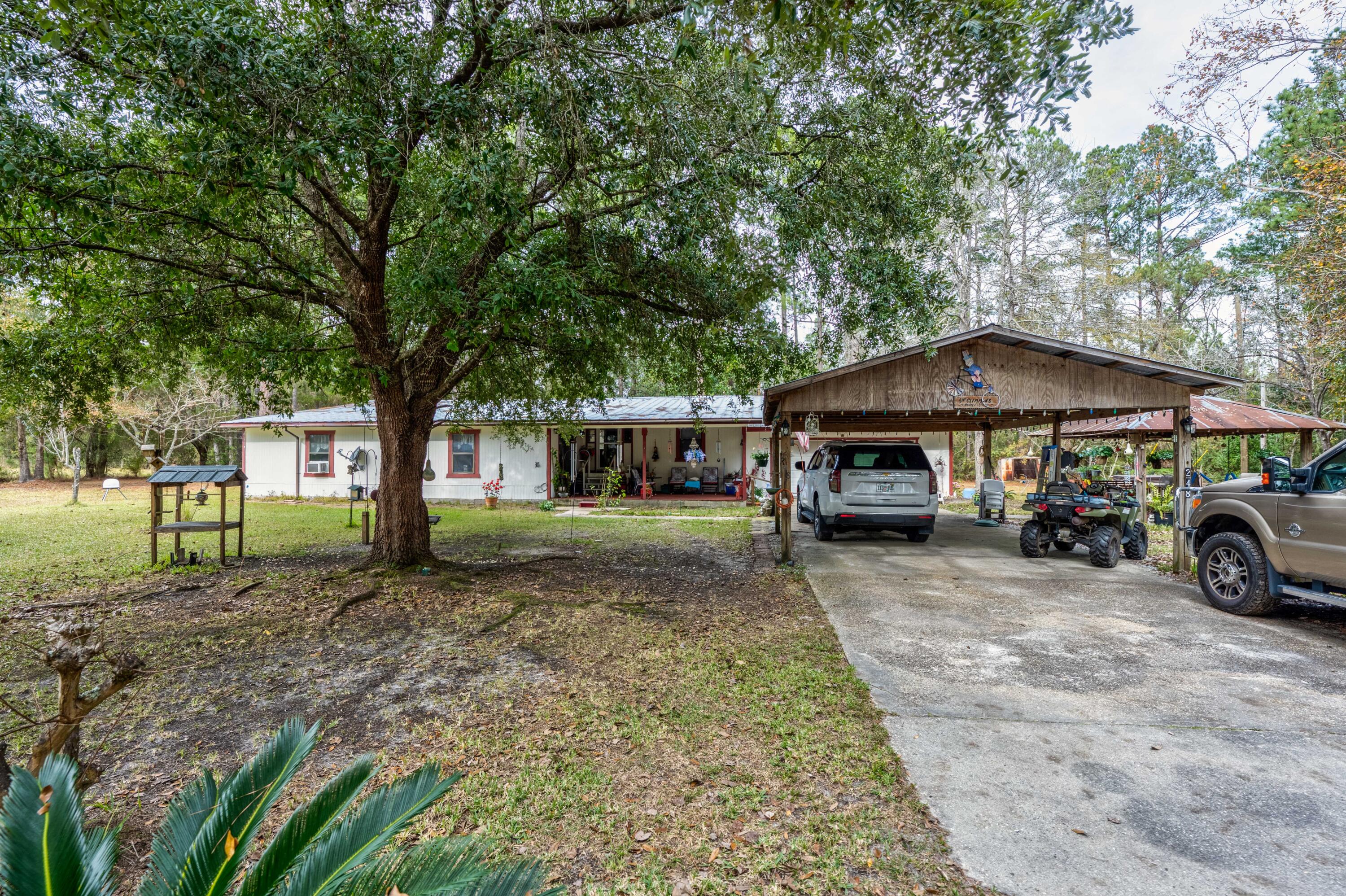 248 Bunny Lane Freeport, FL 32439 - Photo 4 of 27 a front view of a house with garden