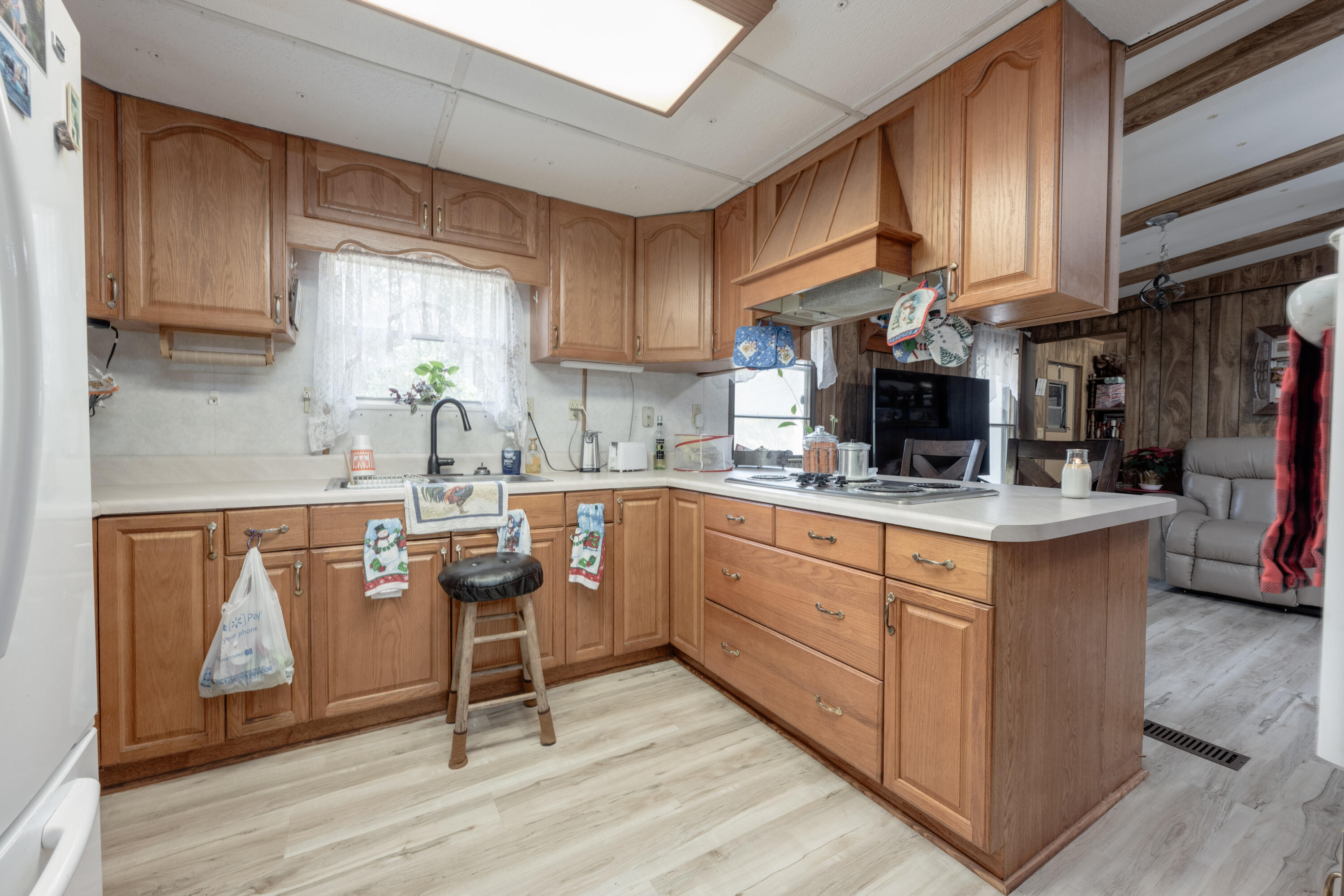 248 Bunny Lane Freeport, FL 32439 - Photo 8 of 27 a kitchen with stainless steel appliances granite countertop a sink a stove a refrigerator cabinets and wooden floor