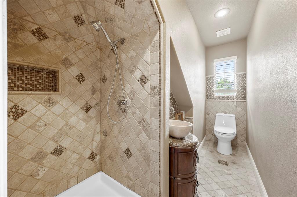 219 Mohundro Road Ferris, TX 75125 - Photo 36 of 40 a bathroom with a toilet and a shower