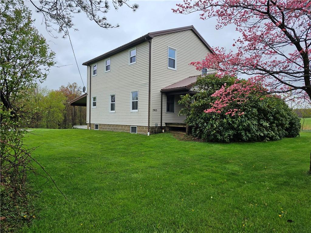 1903 Sandy Lake-Grove City Road Jackson Center, PA 16133 - Photo 1 of 24 a front view of house with garden