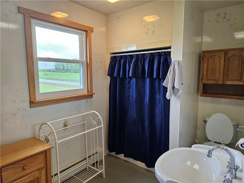 1903 Sandy Lake-Grove City Road Jackson Center, PA 16133 - Photo 13 of 24 a bathroom with a toilet sink vanity and mirror