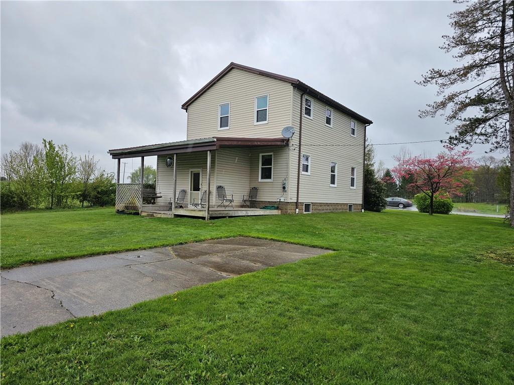 1903 Sandy Lake-Grove City Road Jackson Center, PA 16133 - Photo 2 of 24 a front view of a house with garden