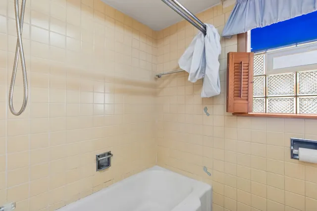 a bathroom with a bathtub and shower