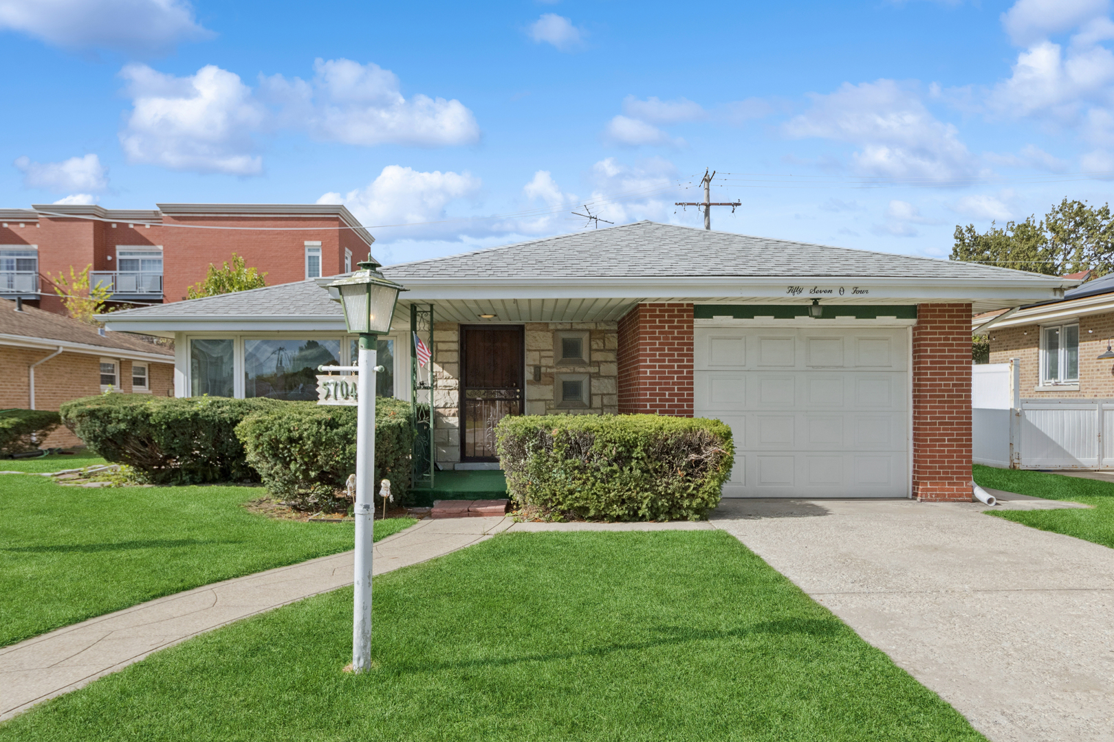 5704 North Ozark Avenue Chicago, IL 60631 - Photo 2 of 24 a front view of a house with garden