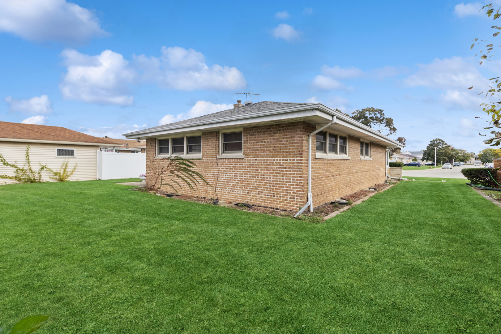 5704 North Ozark Avenue Chicago, IL 60631 - Photo 21 of 24 a view of a house with a yard