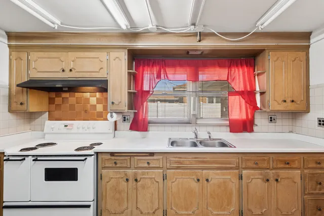 a kitchen with stainless steel appliances a stove a sink and a microwave