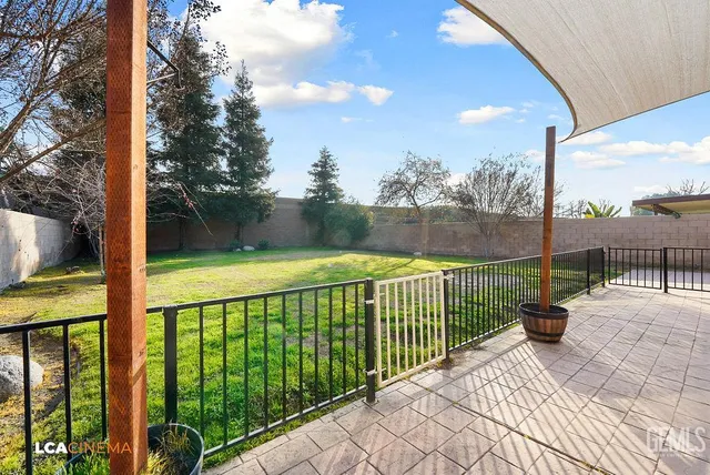 a view of balcony with floor to ceiling windows and wooden fence