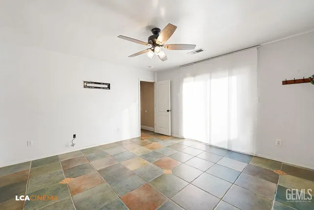 a view of an empty room with a ceiling fan