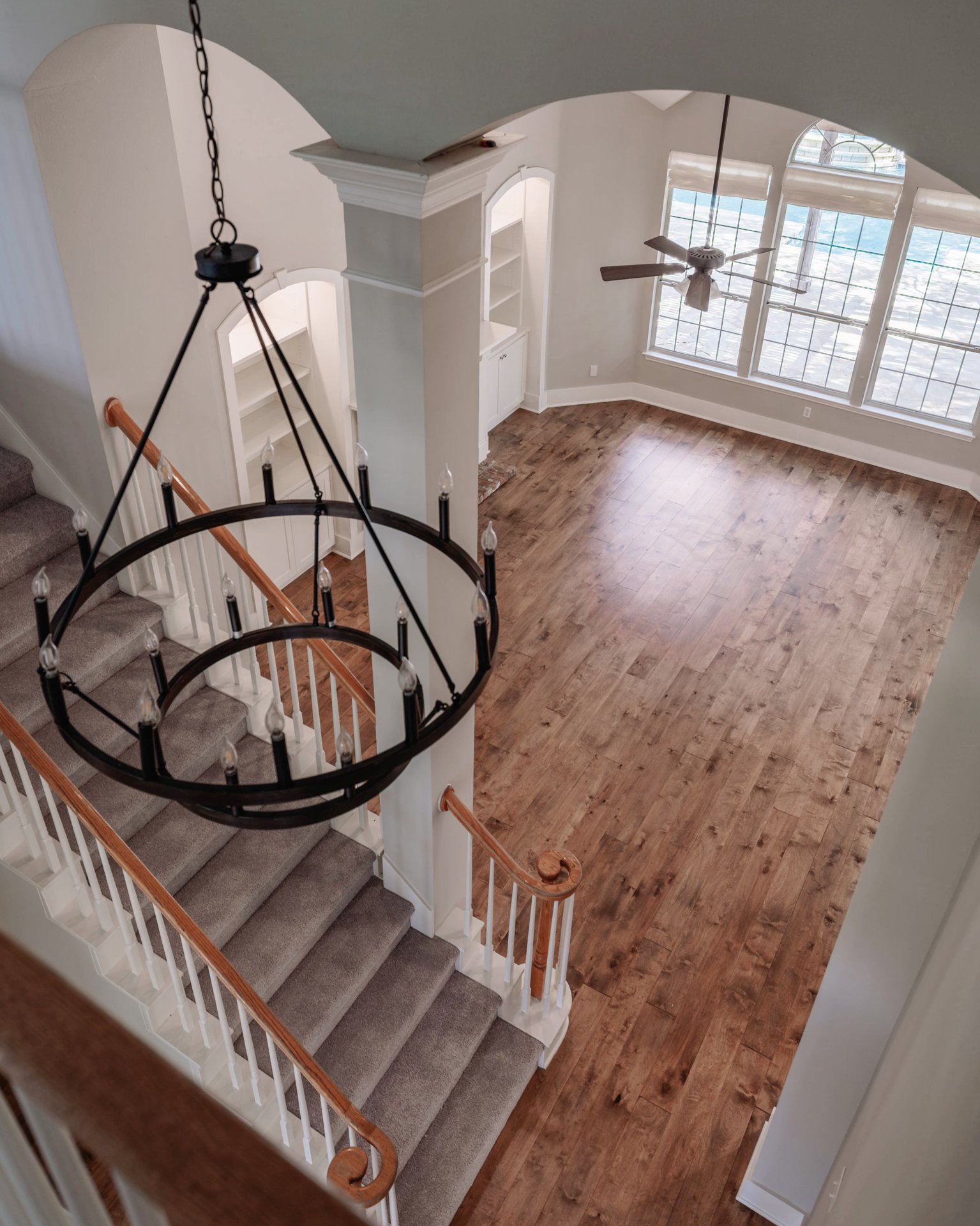 5512 Ballenton Lane Austin, TX 78739 - Photo 25 of 40 A grand chandelier illuminates the entry and an open living space with rich hardwood flooring.