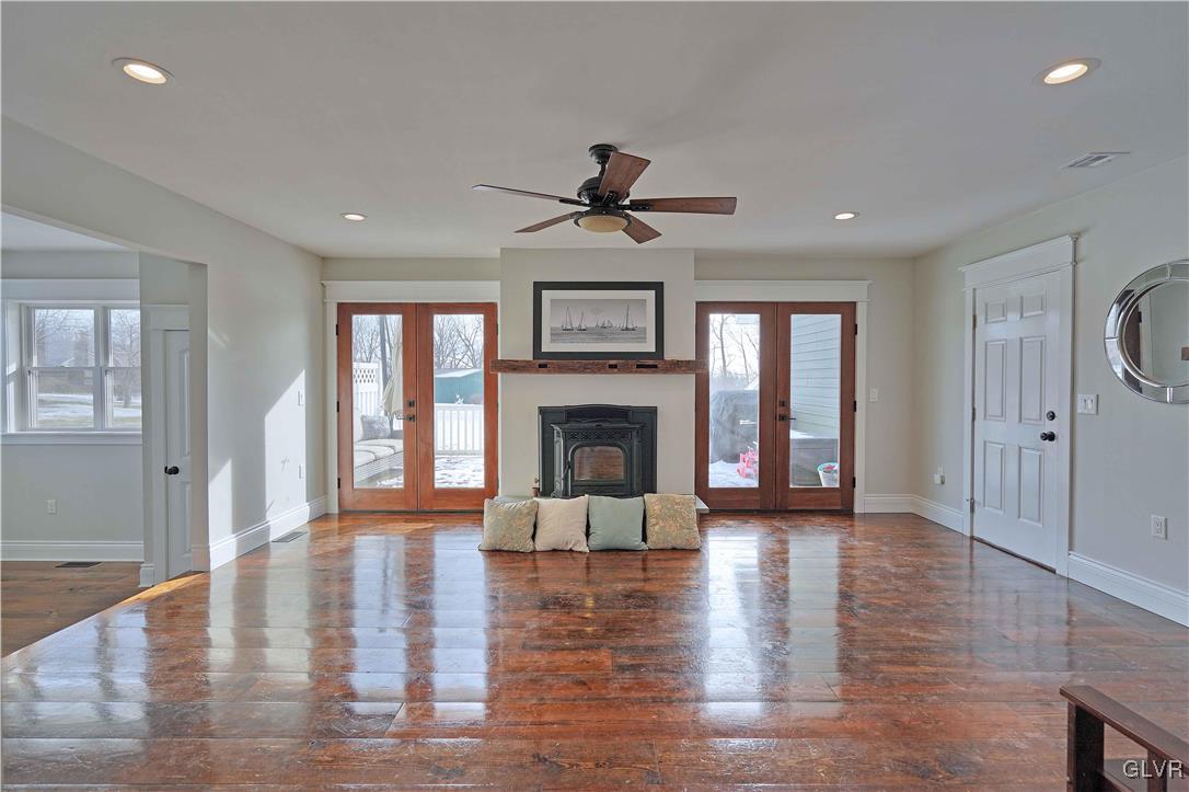 512 Lefevre Road Easton, PA 18040 - Photo 11 of 23 a view of a livingroom with a fireplace wooden floor and windows